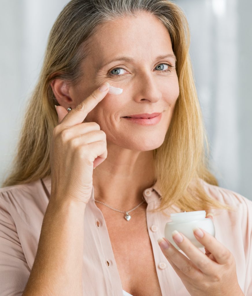 Woman using a cream to improve aging skin